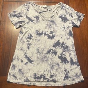 Short sleeve top with crisscrossed neckline.